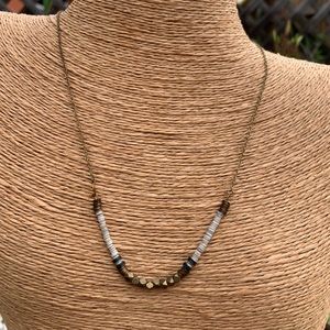 Puka shells and brass necklace